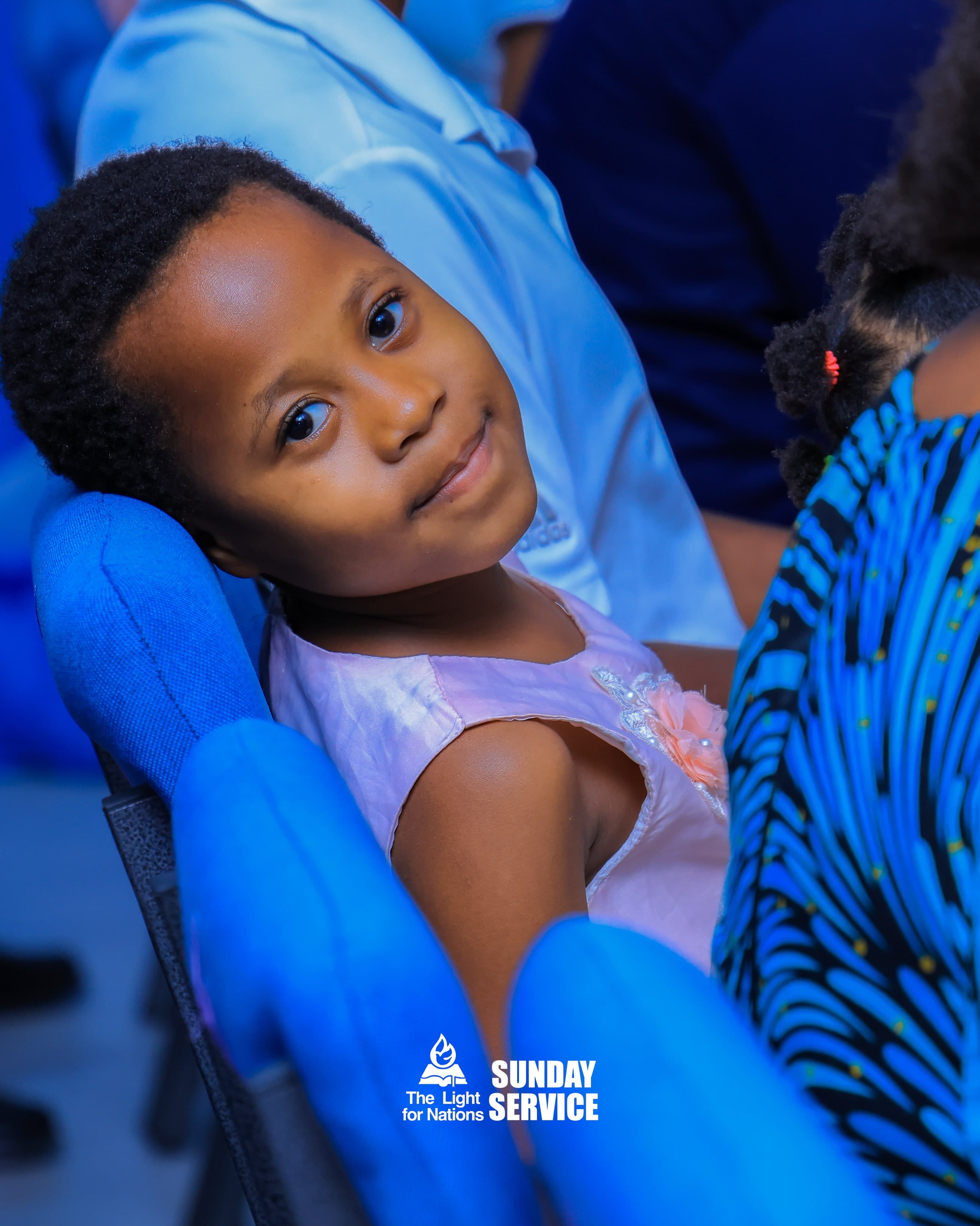 A young attendee at a gathering at The Light for Nations